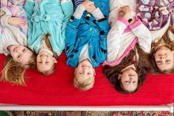 Group of children having fun at pajama party. Cozy home. Top view