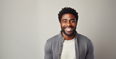 Obraz premium Beautiful black man with smooth healthy face skin. Gorgeous man with a happy smile. Beauty and cosmetics skincare advertising concept.