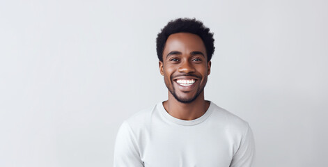 Beautiful black man with smooth healthy face skin. Gorgeous man with a happy smile. Beauty and cosmetics skincare advertising concept.