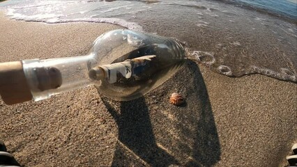 Message in bottle on the beach at summer day travel