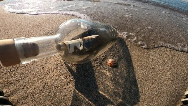 Message in bottle on the beach at summer day travel 
