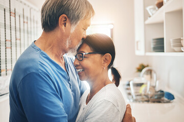 Hug, smile and mature couple kiss in home for care, support or trust together. Embrace, happy man...