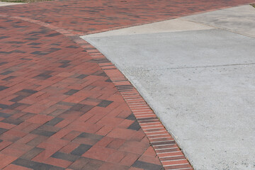 Intersecting curved shapes of concrete and brick paving form an urban textured background, creative copy space, horizontal aspect