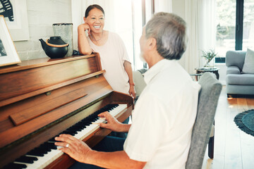 Happy woman, piano or senior man playing a song or music for wife in living room with bonding or entertainment. Smile, keyboard or mature Asian couple in retirement enjoy instrument at modern home