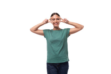 young positive european woman with a ponytail hairstyle is dressed in a green t-shirt on a white background
