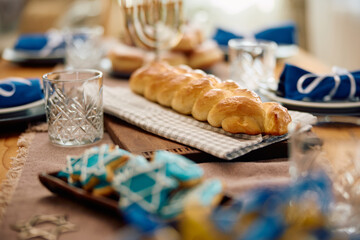 Obraz na płótnie Canvas Traditional Challah bread on dining table for Hanukkah.