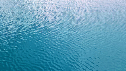 lake water background. gentle waves in light blue color tone. blue lake water background texture...
