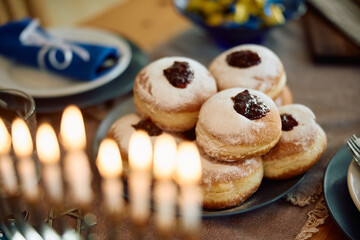 Jam filled donuts on table during Hanukkah celebration.