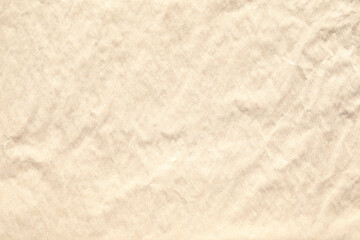 Beige crumpled paper texture with grains macro closeup