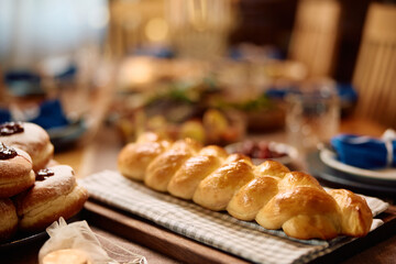 Traditional Challah bread at dining table.