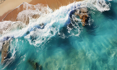 Fototapeta na wymiar Turquoise waves with foam running on the sandy shore.