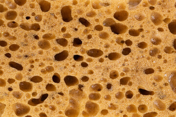 Spongy texture with traces of bubbles. Brown color.