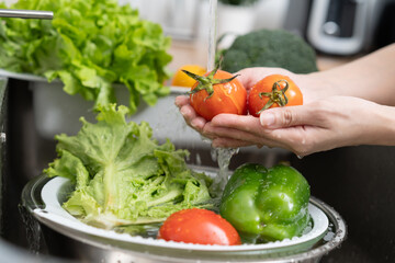 people washing raw vegetables at sink in the kitchen prepare ingredient for cooking