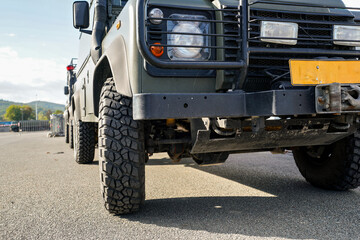 Military truck vehicle, low angle detail to wheels and front light only