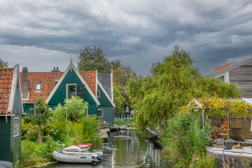 Thick Clouds Over Rural Dutch Houses and Boats on the Canal
