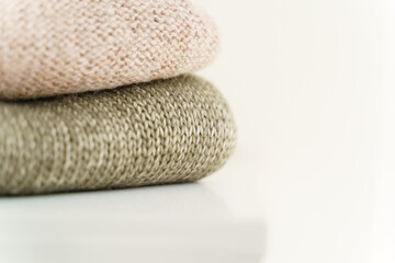 Fototapeta na wymiar Knitted warm sweaters on dresser at home