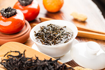 Brewing Chinese tea in ceramic gaiwan during the tea ceremony close-up.