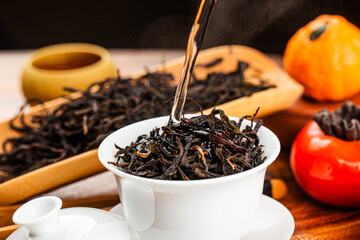 Brewing Chinese tea in ceramic gaiwan during the tea ceremony close-up.