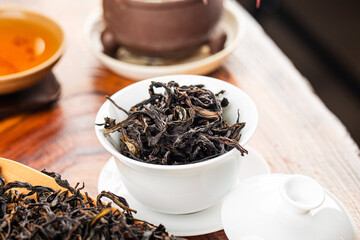 Brewing Chinese tea in ceramic gaiwan during the tea ceremony close-up.