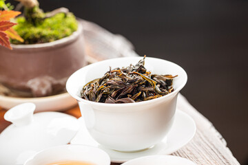 Brewing Chinese tea in ceramic gaiwan during the tea ceremony close-up.