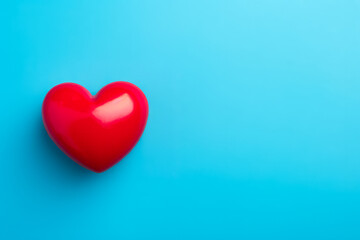 Health Insurance Concept: Flat Lay with Red Heart, Text Space on Blue Background