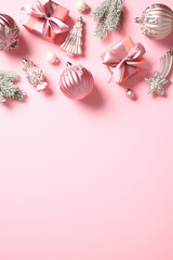 Christmas and New Year pink background with decorations, gifts, bauble. Flat lay, top view.