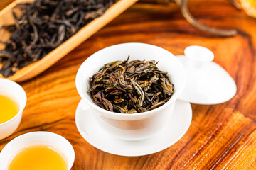 Brewing Chinese tea in ceramic gaiwan during the tea ceremony close-up.