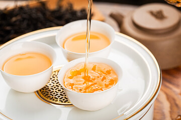 Brewing Chinese tea in ceramic gaiwan during the tea ceremony close-up.