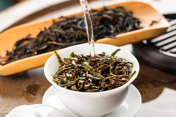 Brewing Chinese tea in ceramic gaiwan during the tea ceremony close-up.