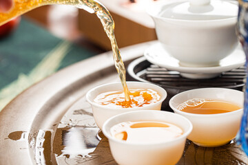 Brewing Chinese tea in ceramic gaiwan during the tea ceremony close-up.