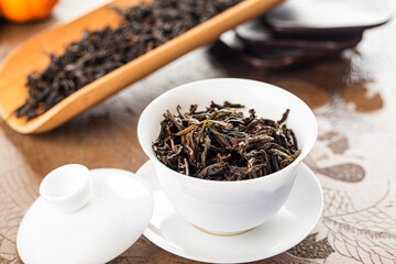 Brewing Chinese tea in ceramic gaiwan during the tea ceremony close-up.
