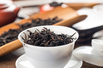 Brewing Chinese tea in ceramic gaiwan during the tea ceremony close-up.