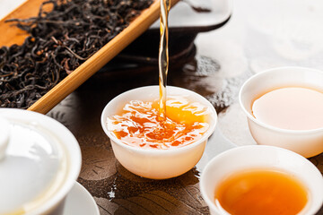 Brewing Chinese tea in ceramic gaiwan during the tea ceremony close-up.