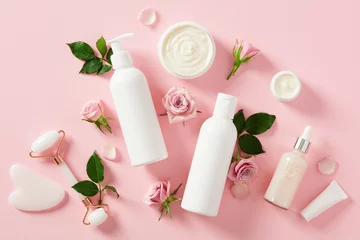 Deurstickers Set of natural organic SPA cosmetics with rose buds and petal on light pink background. © photoguns