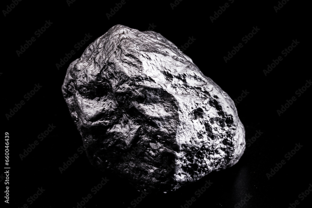 Poster large silver stone, rare silver nugget on black background. Gemstone in high resolution, luxury concept.