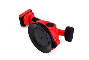 Red rechargeable vibrating vacuum suction cup for laying tiles isolated on a white background.