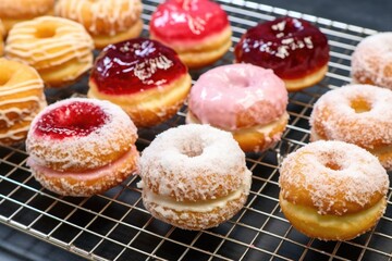 Obraz na płótnie Canvas a fleet of jelly-filled donuts on a bakery cooling rack