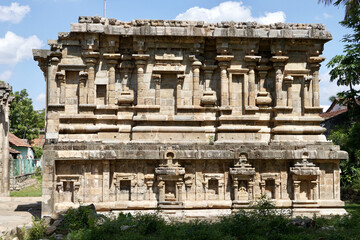 Ruined facade of ancient historic Airavatesvara Temple in Darasuram, Kumbakonam, Tamilnadu. Ruined Stone wall with relief carvings of God sculpture.