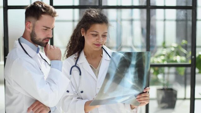 male doctor and female doctors with x-ray results. Professional consulting.