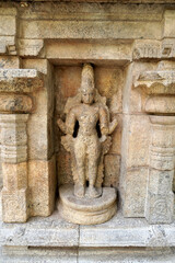 Ancient Hindu God statue in temple. Stone carving of historic God sculpture in Airavatesvara Temple in Darasuram, Kumbakonam, Tamilnadu.
