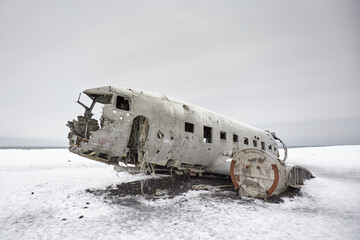 An old airplane abandoned in a snowy landscape, evoking a sense of nostalgia and the passage of time.