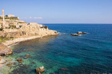 Fototapeta na wymiar Old ruins and rocky coastline in Sicily