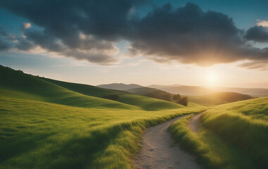 Picturesque winding path through a green grass field in hilly area in morning at dawn against blue sky and clouds