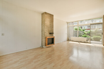 an empty living room with wood floors and a brick fireplace in the room is very clean, but it's all white