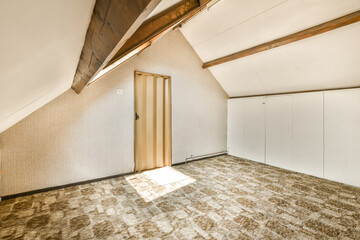 an unfinished room with wood beams and white wallpaper on the walls, there is a wooden door in the corner