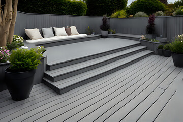 Composite decking in ash grey with three levels deck lights, minimalist sofa and ideal for a landscape gardener