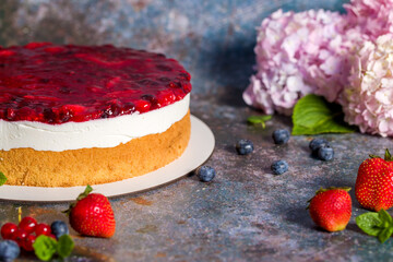 Cheesecake with fresh strawberries, red currants and blueberries