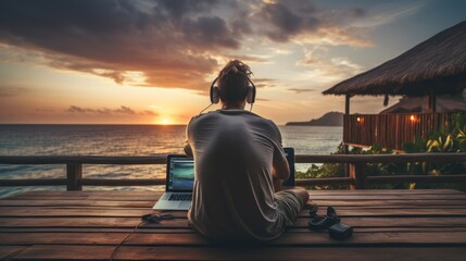 digital nomad man sitting on wooden pier at sea working
