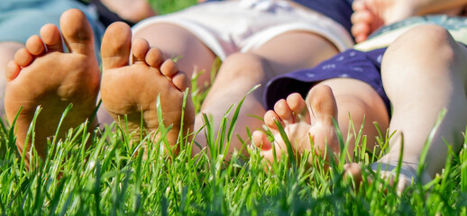 Children's legs on green grass. Selective focus.