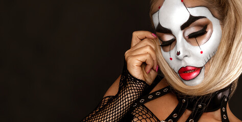 Sexy woman in a Halloween makeup on black background.